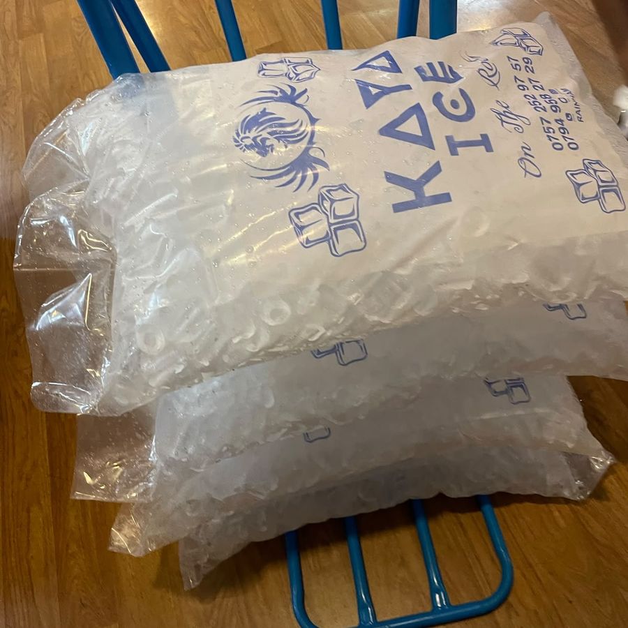 Three 16 kg bags of Kaya Ice tube ice, printed with the Kaya Ice logo, on a delivery trolley